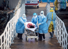 Medical workers at Huoshenshan Hospital transport a patient on February 4, the day the flash-built emergency hospital in Wuhan began admitting COVID-19 patients.