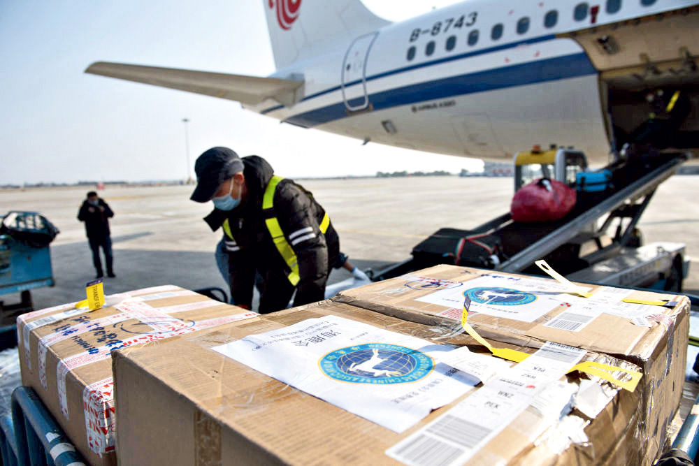An airport worker unloads a shipment of medical supplies from France in Wenzhou, Zhejiang Province, on February 9.
