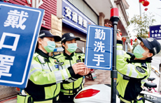 Female traffic cops put up posters with catchphrases for epidemic prevention on their motorcycles on February 13 in Ningde in southeastern China's Fujian Province. While performing traffic duties, they spread knowledge of virus containment through posters and short videos.