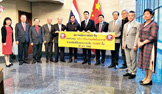 Korn Dabbaransi (sixth left), president of the Thai-Chinese Friendship Association, poses with Minister-Counsellor Yang Xin (sixth right), charge d'affaires of the Chinese Embassy in Thailand, and other guests at a ceremony for the donation of medical masks to China.