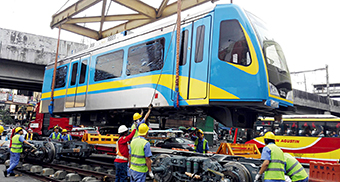 Manila workers assemble a light rail train delivered by China Railway Rolling Stock Corporation (CRRC) Dalian Co., Ltd. on January 16, 2017.