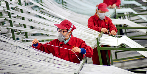 Workers on the production line of an energy-saving materials company in Yiyuan County, Shandong Province, March 25, 2020. (ZHAO DONGSHAN)