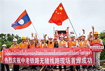 Workers of China Railway No. 2 Engineering Group celebrate the first on-site welding of seamless tracks of the China-Laos Railway in Vientiane, Laos, on June 18, 2020.(Kaikeo Saiyasane)